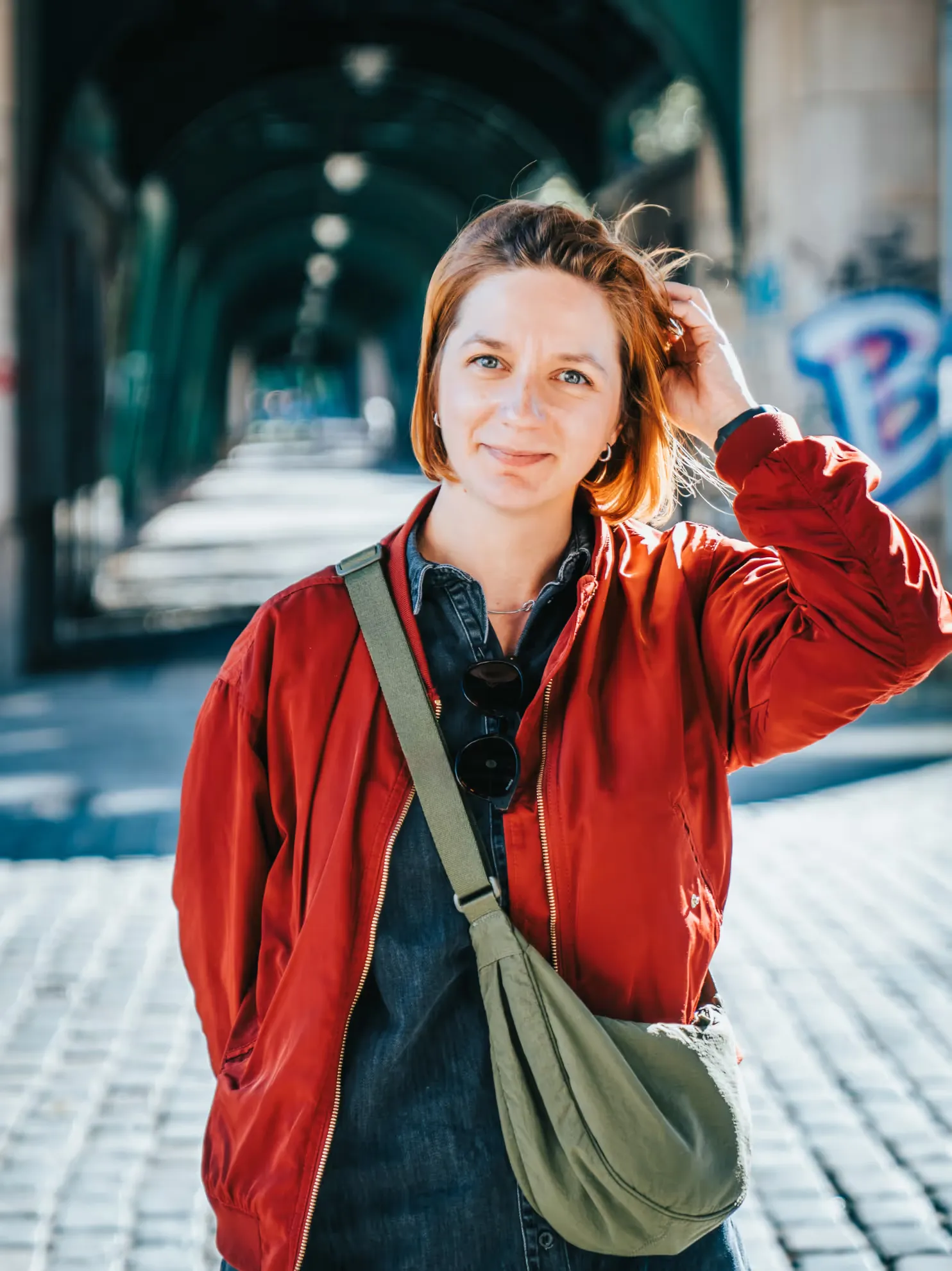 Andra smiling looking straight under the Oberbaumbrücke in Berlin
